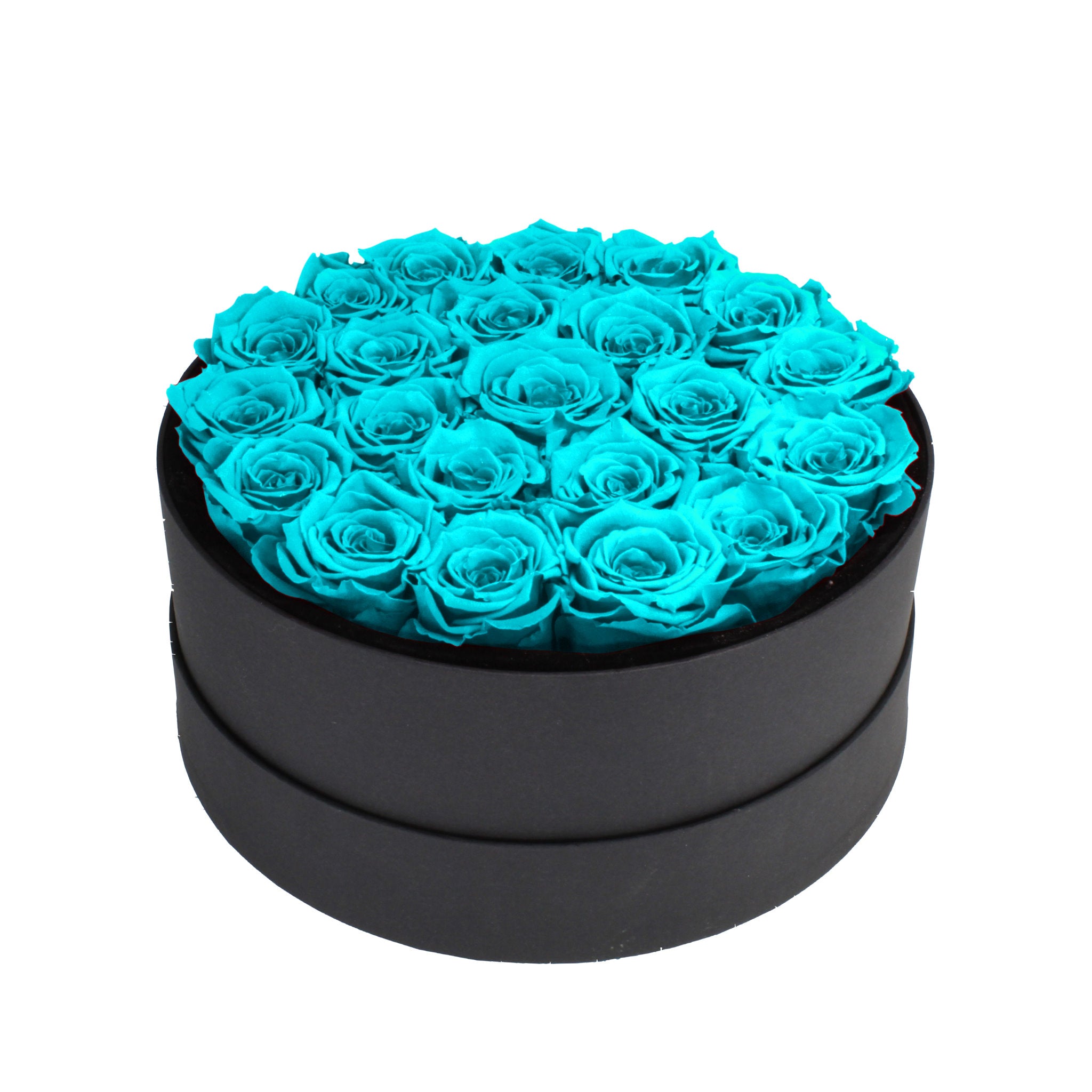 Black round box filled with turquoise roses on a white background