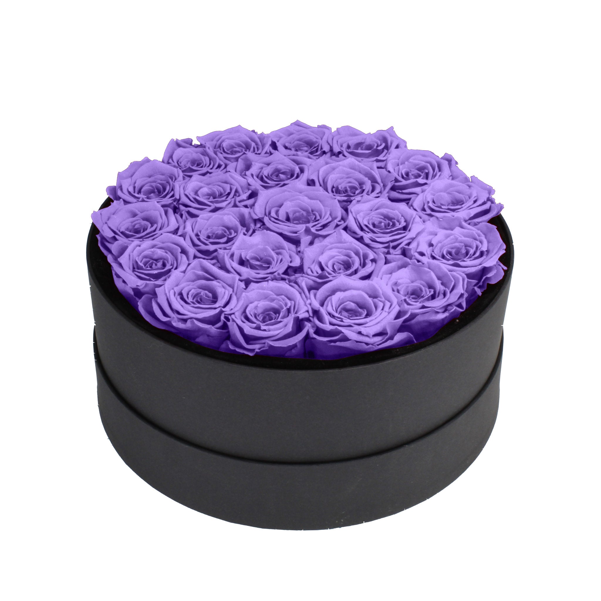 Black round box filled with purple roses on a white background