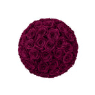 Round arrangement of dark red roses on a white background