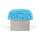 Decorative box with blue rose arrangement on a white background