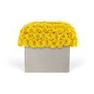 Decorative box with yellow rose-like flowers on a white background