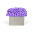 Square gray box with a scalloped purple rose top on a white background