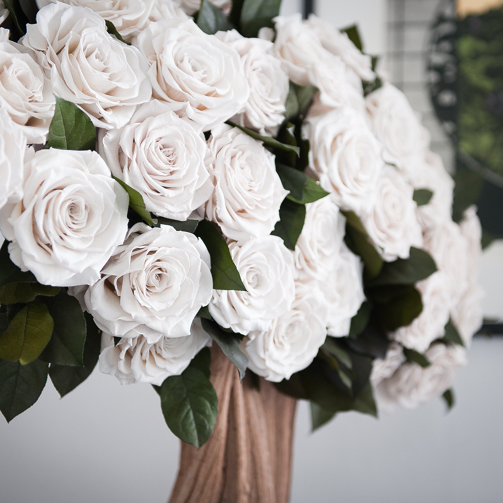 Bouquet of white roses in a vase with a blurred background